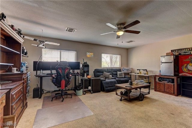9091 Jumping Jacks Ave, Las Vegas, NV 89178 - living area with a ceiling fan, light carpet, a desk, and a textured ceiling