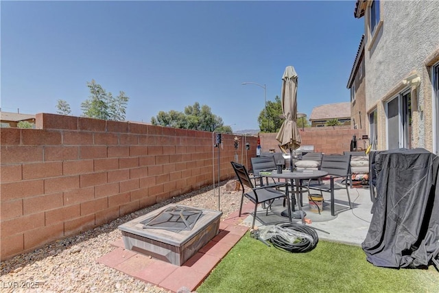 9091 Jumping Jacks Ave, Las Vegas, NV 89178 - fenced backyard featuring a fire pit, a patio area, and outdoor dining space