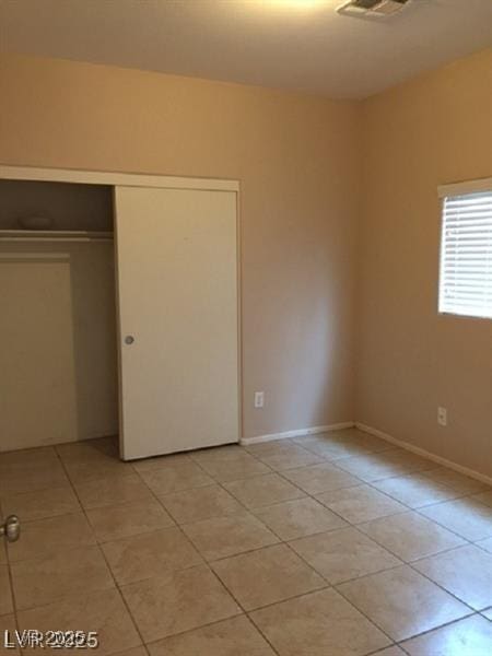 9091 Jumping Jacks Ave, Las Vegas, NV 89178 - unfurnished bedroom featuring light tile patterned flooring and a closet