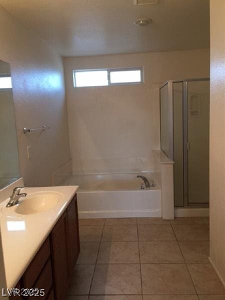 9091 Jumping Jacks Ave, Las Vegas, NV 89178 - bathroom with vanity, a garden tub, tile patterned floors, and a stall shower