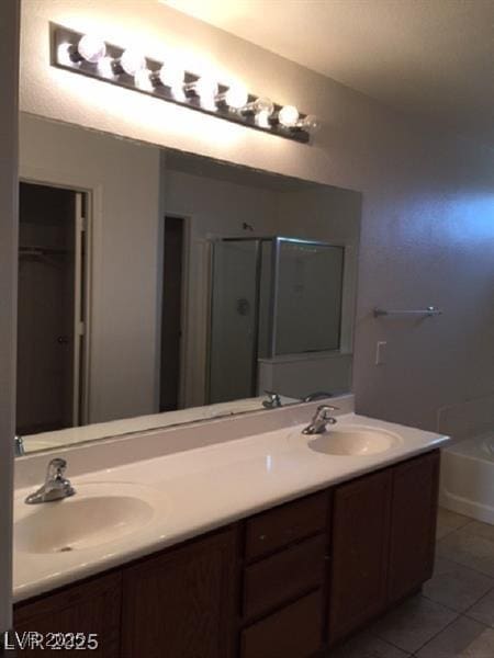 9091 Jumping Jacks Ave, Las Vegas, NV 89178 - full bathroom with double vanity, tile patterned flooring, a tub, a shower, and a closet