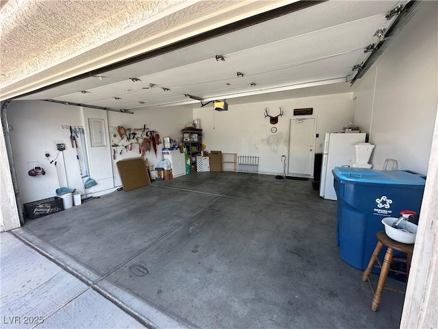 8337 Ruby Heights Ave, Las Vegas, NV 89117 - garage featuring freestanding refrigerator, a garage door opener, and electric panel