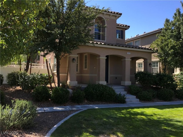 3175 Obscured Light Walk, Henderson, NV 89044 - mediterranean / spanish house featuring stucco siding, covered porch, and a tile roof