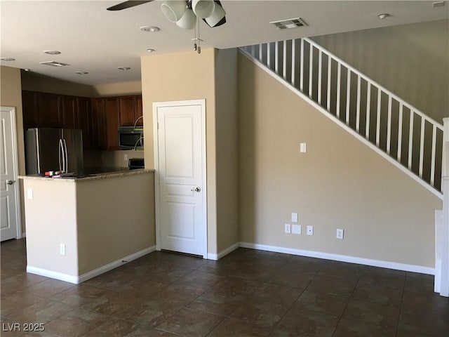 3175 Obscured Light Walk, Henderson, NV 89044 - kitchen with freestanding refrigerator, stainless steel microwave, ceiling fan, a peninsula, and baseboards