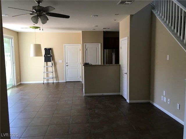 3175 Obscured Light Walk, Henderson, NV 89044 - unfurnished living room with a ceiling fan, dark tile patterned floors, and baseboards