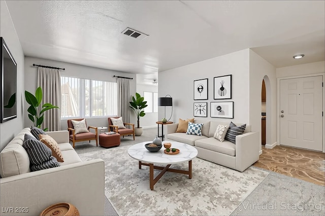 1846 N Decatur Blvd Unit 104, Las Vegas, NV 89108 - living room with arched walkways and light carpet