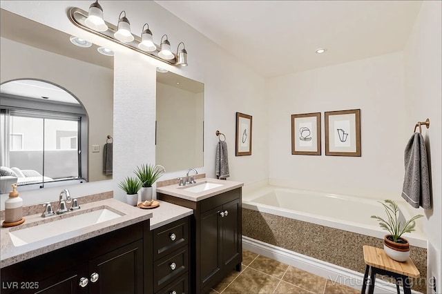 1846 N Decatur Blvd Unit 104, Las Vegas, NV 89108 - bathroom featuring two vanities, a garden tub, and tile patterned flooring