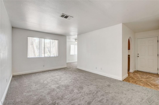 1846 N Decatur Blvd Unit 104, Las Vegas, NV 89108 - carpeted spare room featuring arched walkways and ceiling fan