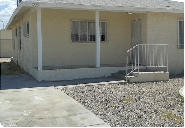 1225 W Van Buren Ave, Las Vegas, NV 89106 - view of exterior entry featuring stucco siding and roof with shingles