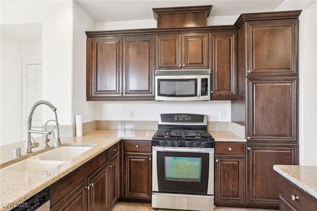 8341 Lower Trailhead Ave, Las Vegas, NV 89113 - kitchen with appliances with stainless steel finishes, a sink, light stone countertops, and dark brown cabinets