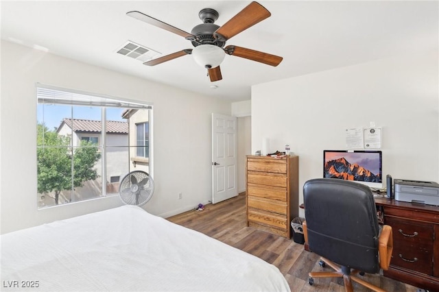 8341 Lower Trailhead Ave, Las Vegas, NV 89113 - bedroom with wood finished floors, an office area, baseboards, and a ceiling fan