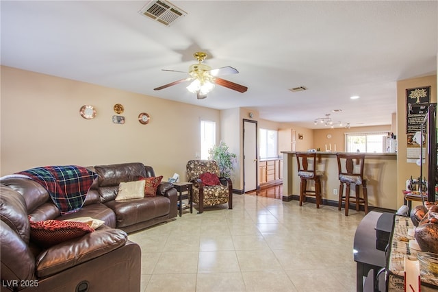 7801 Olympus Ave, Las Vegas, NV 89131 - living area featuring light tile patterned floors and ceiling fan