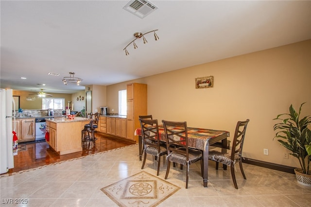 7801 Olympus Ave, Las Vegas, NV 89131 - dining room featuring light tile patterned floors, a ceiling fan, and track lighting