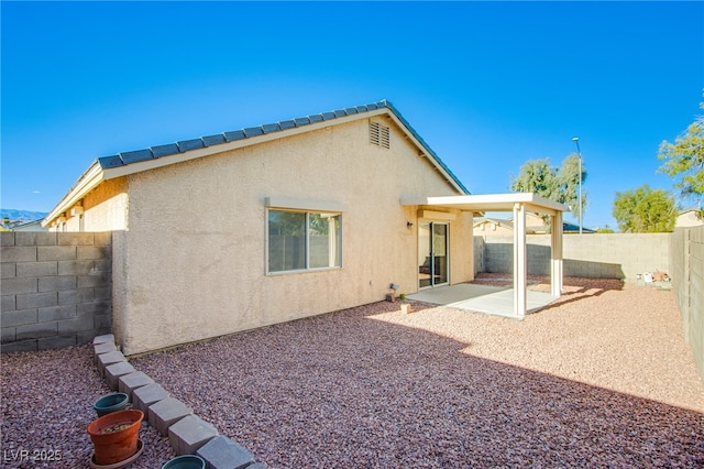 7801 Olympus Ave, Las Vegas, NV 89131 - back of house featuring stucco siding, a fenced backyard, and a patio area