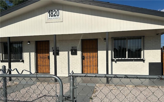 1820 Yale St, North Las Vegas, NV 89030 - view of front facade featuring brick siding and covered porch