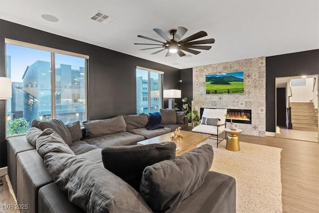 8055 Haywood Estate Ave, Las Vegas, NV 89113 - living room with wood finished floors, ceiling fan, healthy amount of natural light, and a tiled fireplace