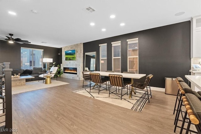 8055 Haywood Estate Ave, Las Vegas, NV 89113 - dining space with a large fireplace, light wood-style floors, recessed lighting, and a ceiling fan