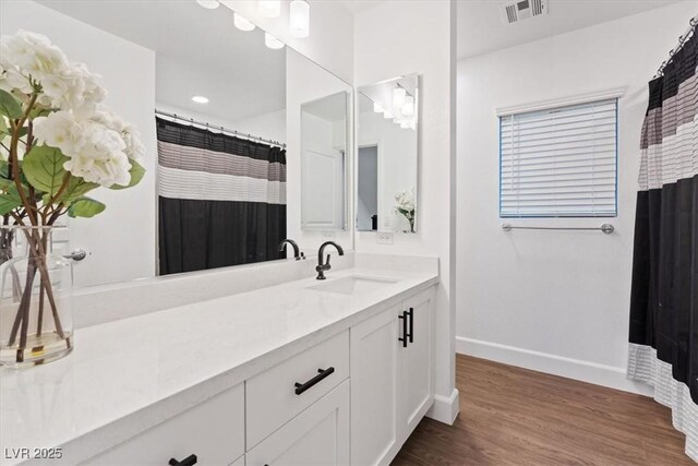 8055 Haywood Estate Ave, Las Vegas, NV 89113 - full bath featuring vanity, wood finished floors, and a shower with curtain