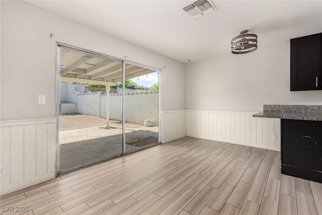 1704 Kismet Cir, Las Vegas, NV 89108 - empty room with a wainscoted wall and light wood-type flooring