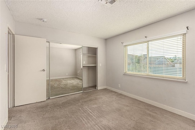 1704 Kismet Cir, Las Vegas, NV 89108 - unfurnished bedroom with carpet floors, a textured ceiling, a closet, and baseboards