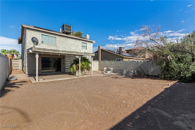 1704 Kismet Cir, Las Vegas, NV 89108 - back of property with a patio area, central AC unit, a fenced backyard, a chimney, and stucco siding