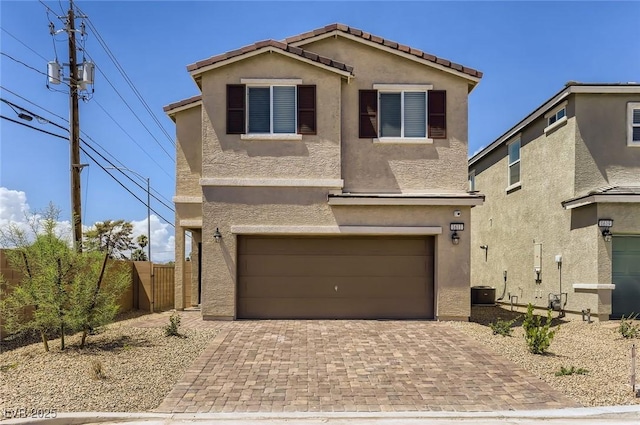 1611 Prairie Fields Ct, Las Vegas, NV 89115 - traditional-style home with an attached garage, stucco siding, decorative driveway, and a gate
