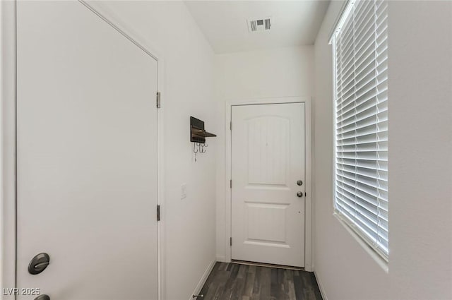 1611 Prairie Fields Ct, Las Vegas, NV 89115 - doorway to outside featuring dark wood-style floors and baseboards