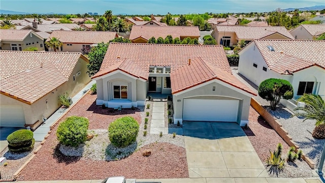 9813 Folsom Dr, Las Vegas, NV 89134 - mediterranean / spanish house featuring a residential view, driveway, a garage, stucco siding, and a tile roof