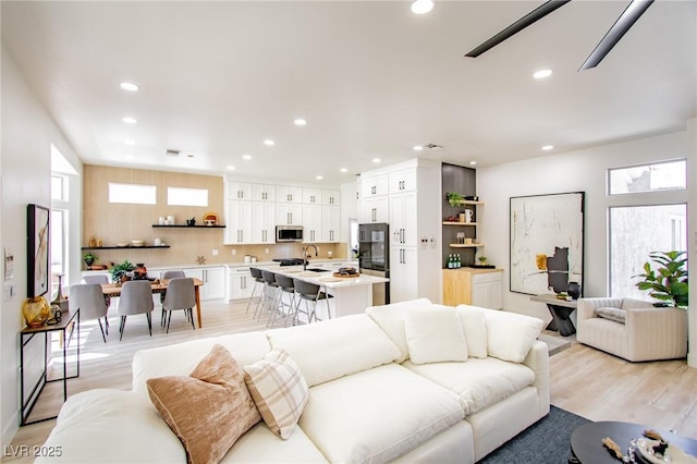 9813 Folsom Dr, Las Vegas, NV 89134 - living room featuring healthy amount of natural light, recessed lighting, and light wood-style flooring