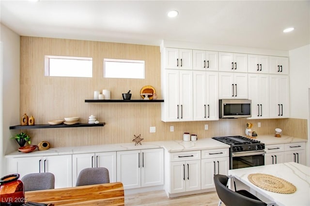 9813 Folsom Dr, Las Vegas, NV 89134 - kitchen with appliances with stainless steel finishes, white cabinetry, light stone countertops, open shelves, and recessed lighting