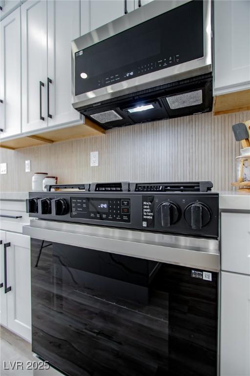 9813 Folsom Dr, Las Vegas, NV 89134 - kitchen with appliances with stainless steel finishes, white cabinetry, and light countertops