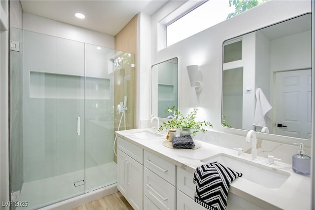 9813 Folsom Dr, Las Vegas, NV 89134 - full bath with double vanity, a stall shower, wood finished floors, and recessed lighting