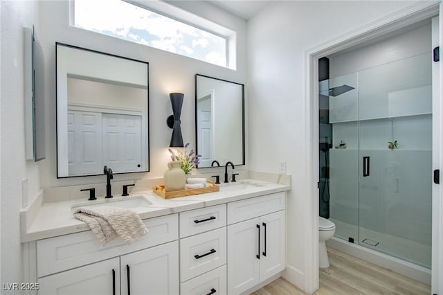 10709 Hunters Woods Pl, Las Vegas, NV 89134 - full bath featuring toilet, double vanity, wood finished floors, and a shower stall