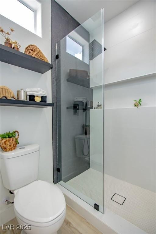 10709 Hunters Woods Pl, Las Vegas, NV 89134 - bathroom featuring toilet, tiled shower, and wood finished floors