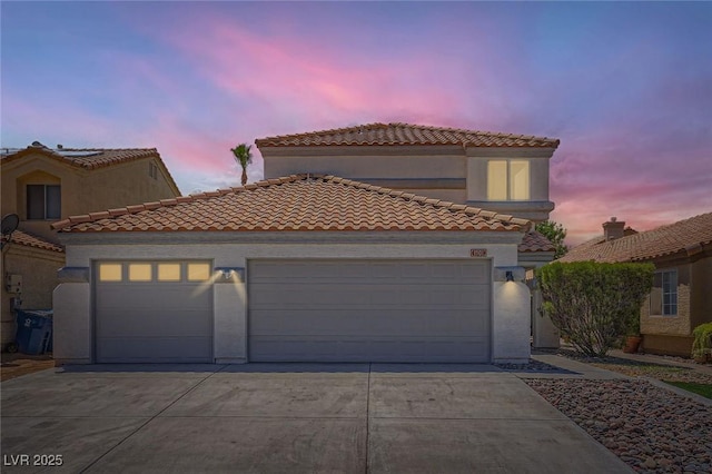 1501 Lucia Dr, Las Vegas, NV 89128 - mediterranean / spanish-style home with concrete driveway, a garage, a tiled roof, and stucco siding
