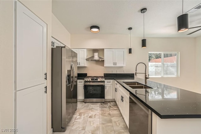 1501 Lucia Dr, Las Vegas, NV 89128 - kitchen with appliances with stainless steel finishes, wall chimney exhaust hood, a peninsula, light marble finish floors, and white cabinetry