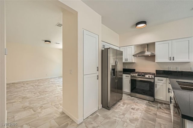 1501 Lucia Dr, Las Vegas, NV 89128 - kitchen with stainless steel appliances, wall chimney exhaust hood, dark countertops, and light marble finish flooring