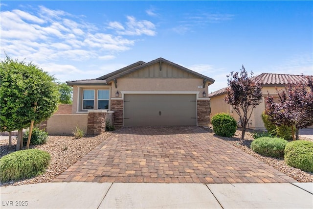 2207 Valdina St, Henderson, NV 89044 - view of front facade with decorative driveway, stucco siding, an attached garage, and stone siding
