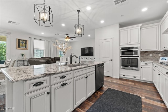 2207 Valdina St, Henderson, NV 89044 - kitchen featuring a chandelier, appliances with stainless steel finishes, recessed lighting, white cabinetry, and tasteful backsplash