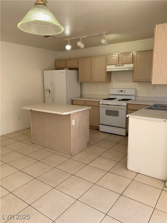6470 Shining Sand Ave, Las Vegas, NV 89142 - kitchen with white appliances, under cabinet range hood, a center island, and light countertops