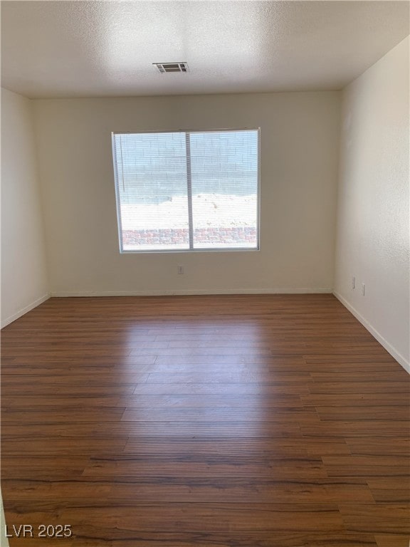 6470 Shining Sand Ave, Las Vegas, NV 89142 - spare room with dark wood-type flooring and baseboards