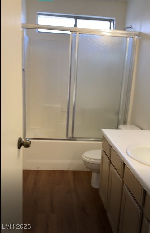 6470 Shining Sand Ave, Las Vegas, NV 89142 - bathroom featuring vanity, combined bath / shower with glass door, plenty of natural light, and wood finished floors