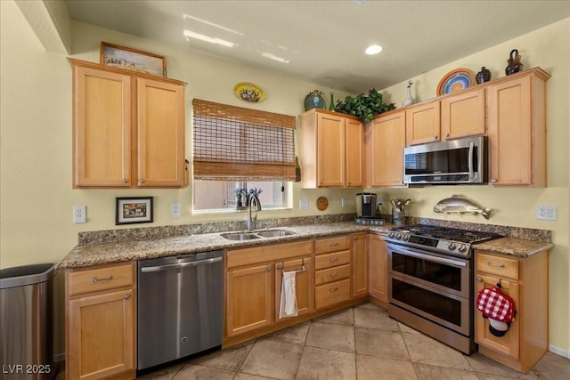 7817 Homing Pigeon St, North Las Vegas, NV 89084 - kitchen featuring stainless steel appliances, light brown cabinetry, light tile patterned floors, and recessed lighting