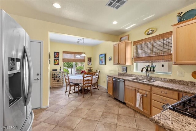 7817 Homing Pigeon St, North Las Vegas, NV 89084 - kitchen with appliances with stainless steel finishes, hanging light fixtures, stone counters, and recessed lighting