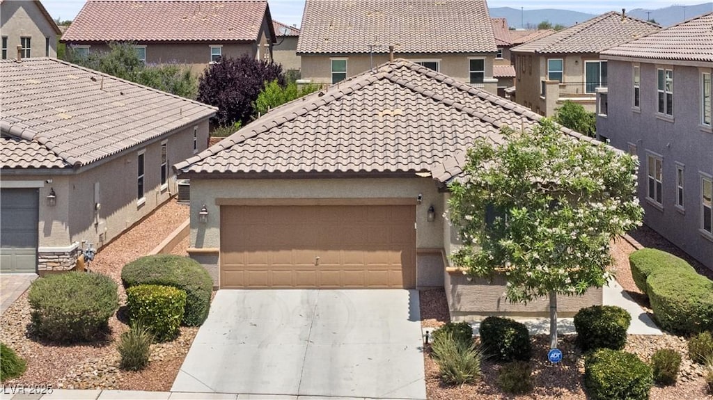 9288 Valley Betica Ave, Las Vegas, NV 89148 - view of front of home with concrete driveway, a tiled roof, an attached garage, and a residential view