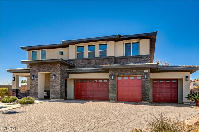 7736 Tioga Ridge Ct, Las Vegas, NV 89117 - prairie-style house with stucco siding, a garage, stone siding, and decorative driveway