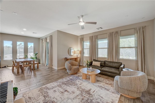 7736 Tioga Ridge Ct, Las Vegas, NV 89117 - living room featuring wood finished floors, ceiling fan, healthy amount of natural light, and recessed lighting