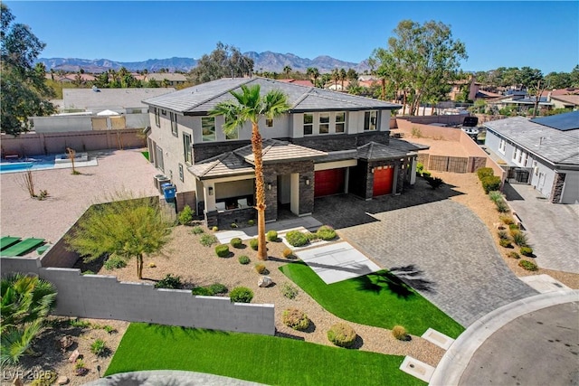 7736 Tioga Ridge Ct, Las Vegas, NV 89117 - view of front of property with decorative driveway, stone siding, a residential view, an attached garage, and stucco siding