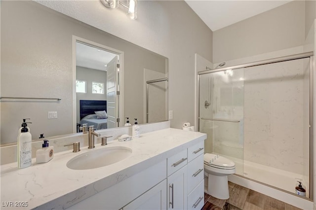 7736 Tioga Ridge Ct, Las Vegas, NV 89117 - ensuite bathroom with a shower stall, vanity, and wood finished floors