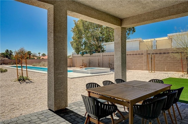 7736 Tioga Ridge Ct, Las Vegas, NV 89117 - fenced backyard with a patio, an in-ground hot tub, and outdoor dining space